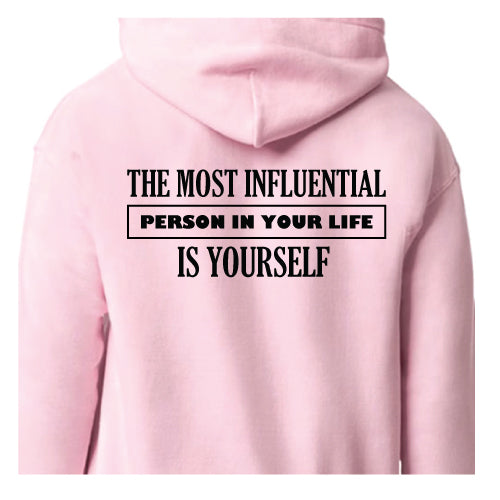 Empowered Life Designs hoodie with bold black lettering reading "The Most Influential Person in Your Life Is Yourself" on a back of light pink hoodies.
